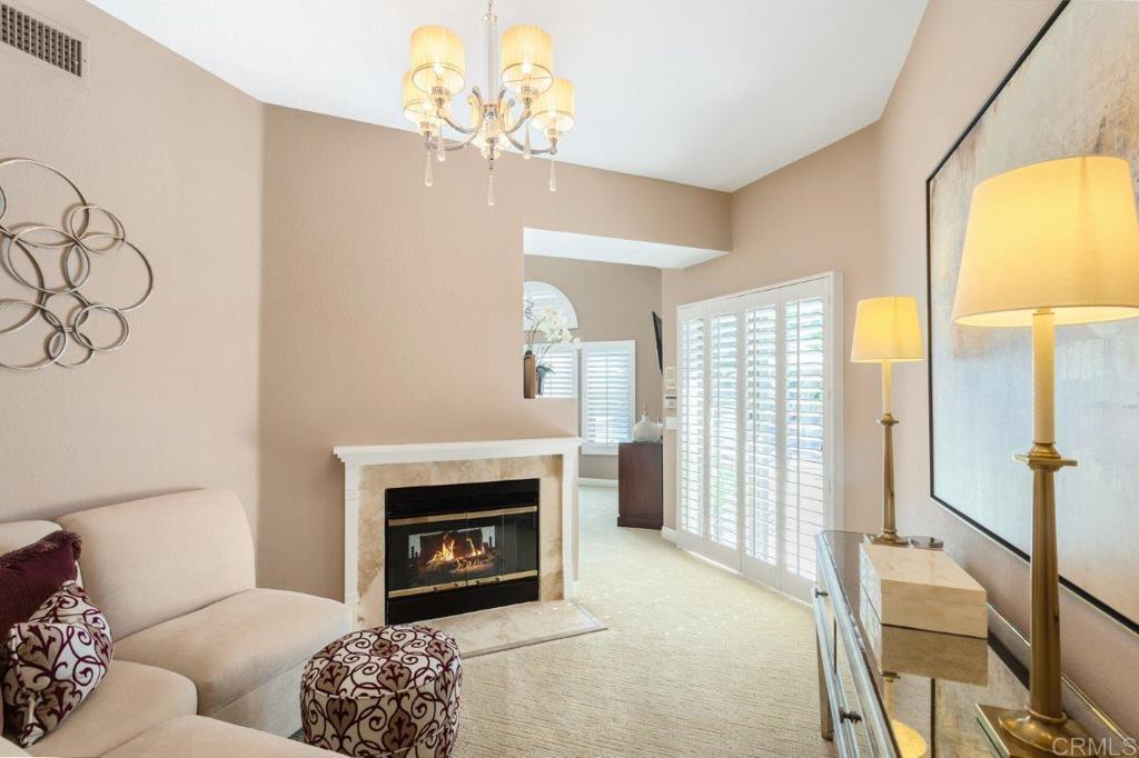 9369 Quail Canyon Road El Cajon, CA 92021 - Photo 24 of 43 a living room with furniture a fireplace and a flat screen tv