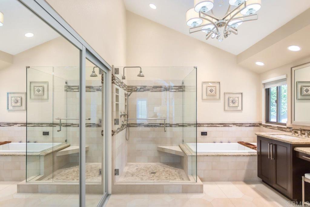 9369 Quail Canyon Road El Cajon, CA 92021 - Photo 28 of 43 a bathroom with a bathtub shower sink and mirror
