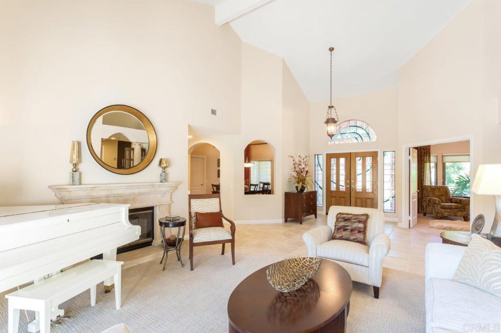9369 Quail Canyon Road El Cajon, CA 92021 - Photo 6 of 43 a living room with furniture a fireplace and a floor to ceiling window