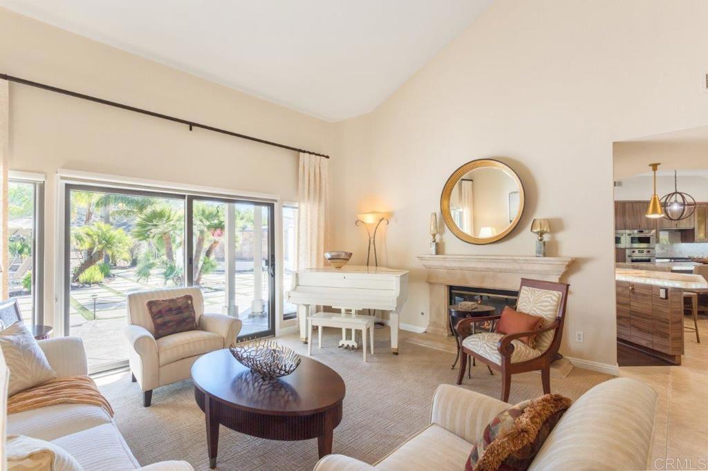 9369 Quail Canyon Road El Cajon, CA 92021 - Photo 7 of 43 a living room with furniture a fireplace a large window and a large window