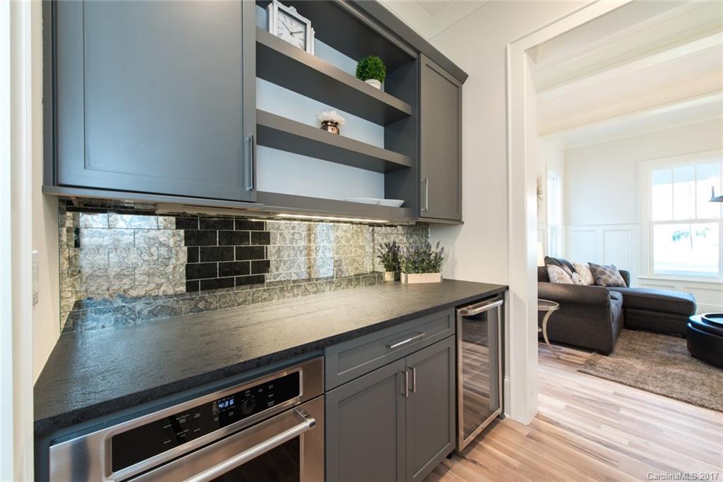 501 McAlway Road Charlotte, NC 28211 - Photo 11 of 24 a kitchen with a sink stove and cabinets