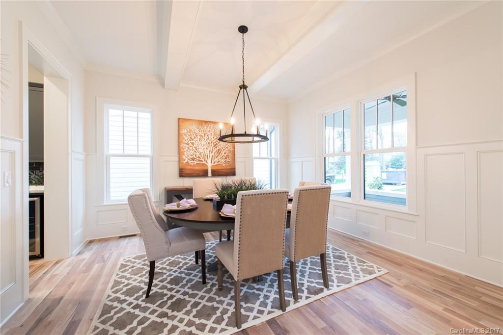 501 McAlway Road Charlotte, NC 28211 - Photo 12 of 24 a dining room with furniture a chandelier and wooden floor