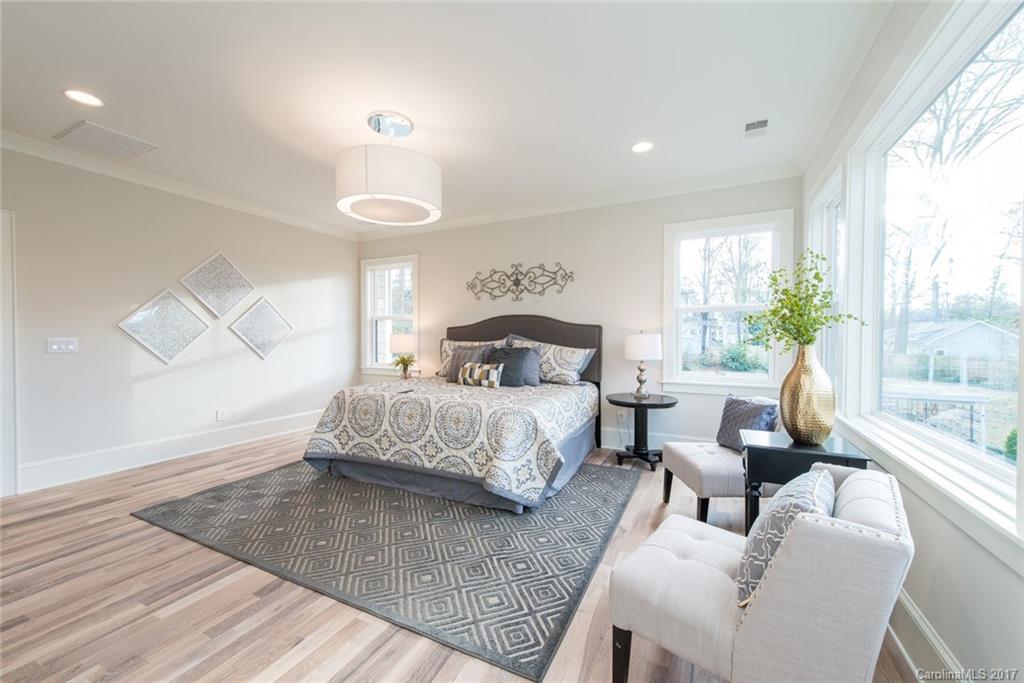 501 McAlway Road Charlotte, NC 28211 - Photo 17 of 24 a bedroom with a bed and a chandelier