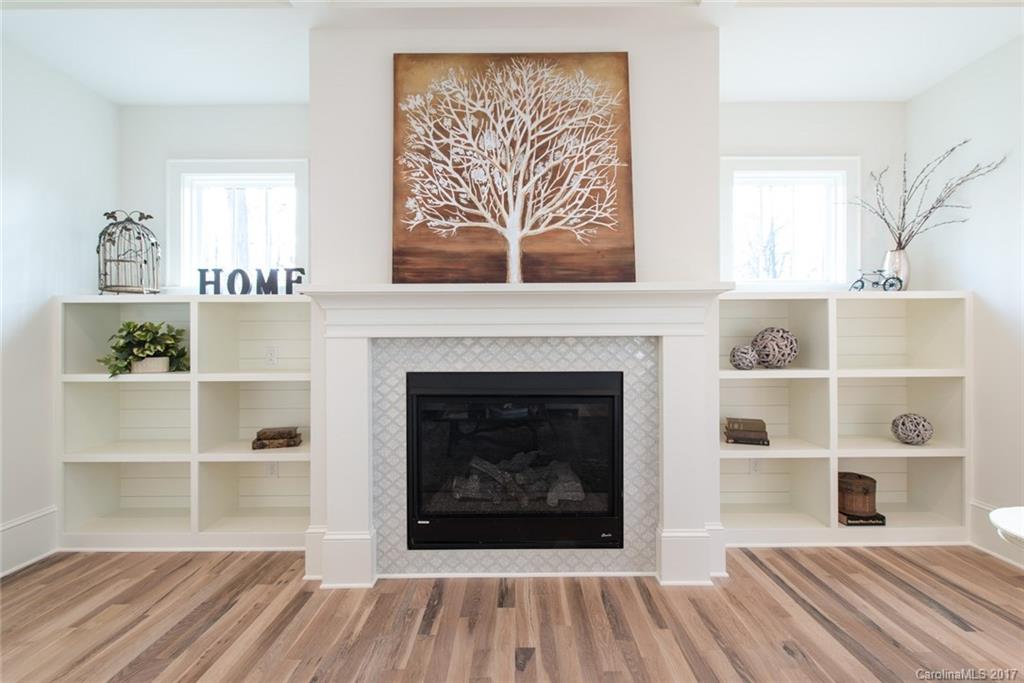 501 McAlway Road Charlotte, NC 28211 - Photo 4 of 24 a living room with a fireplace and a window