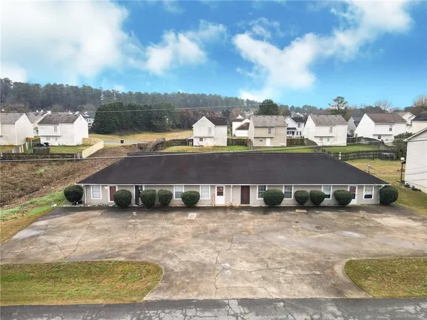 an aerial view of residential houses with outdoor space