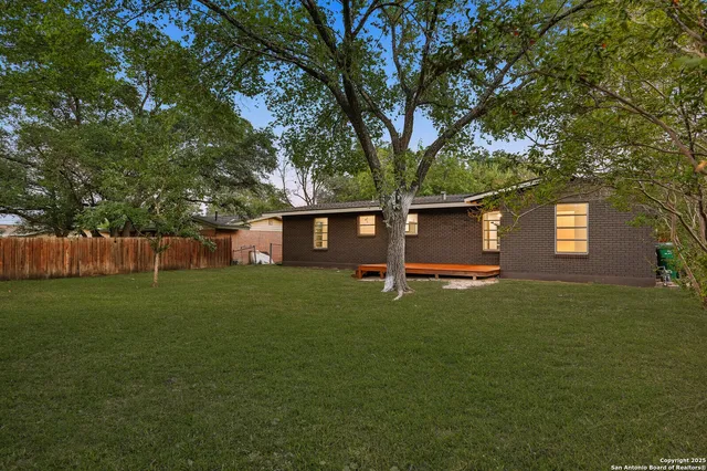 a view of a house with a backyard