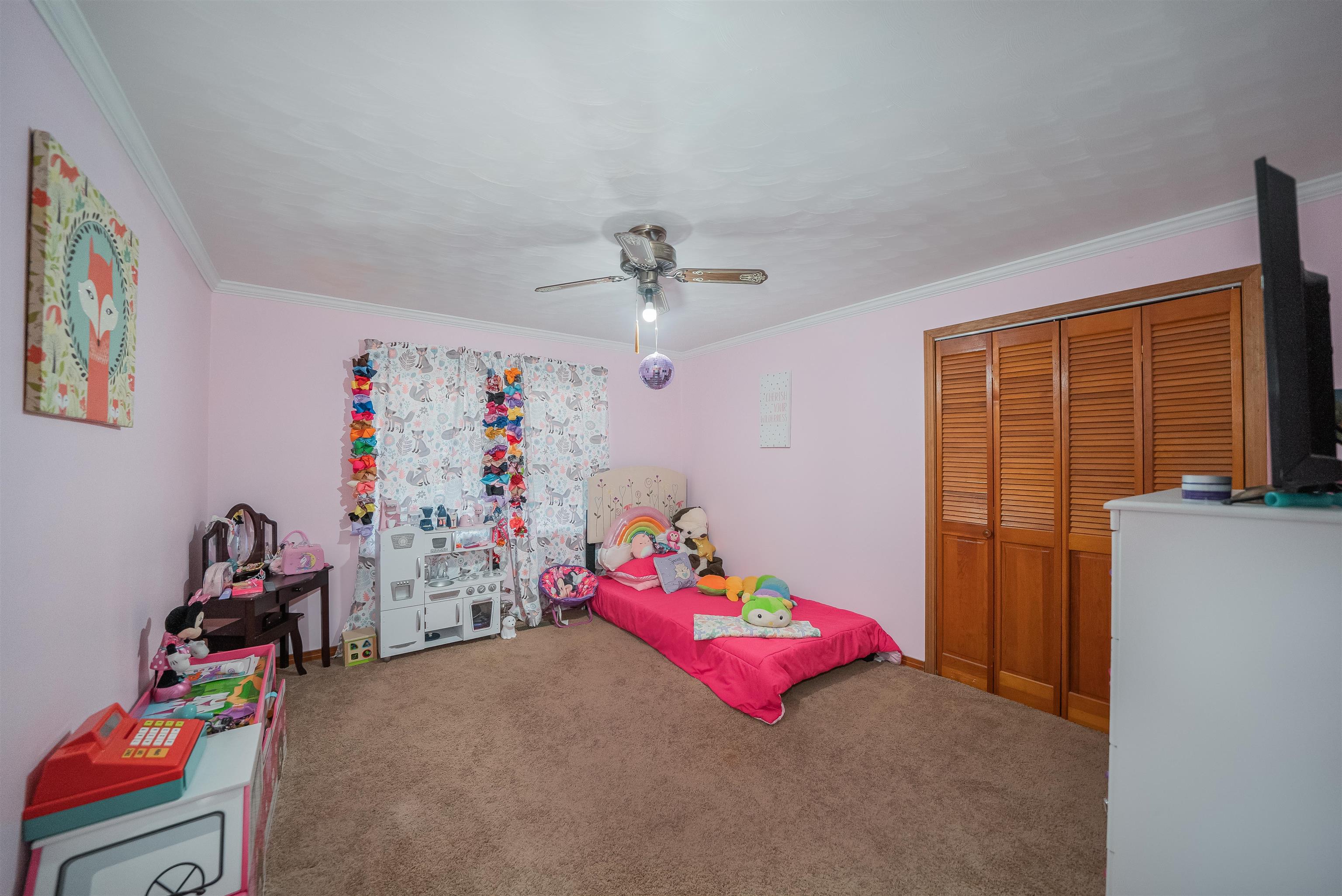 1315 Bishop Road Middleton, TN 38052 - Photo 15 of 31 Bedroom with carpet flooring, ceiling fan, ornamental molding, and a closet