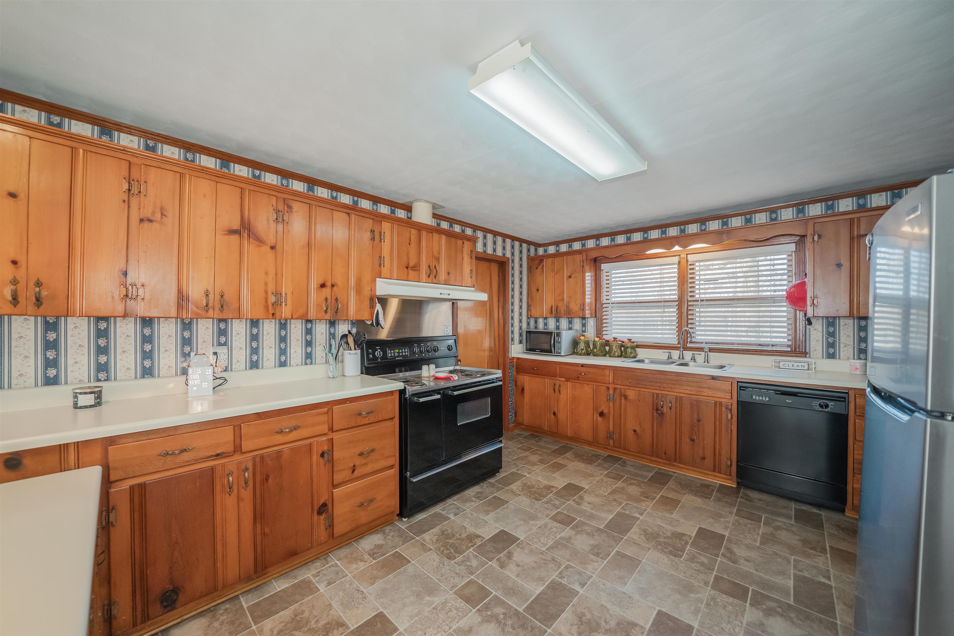 1315 Bishop Road Middleton, TN 38052 - Photo 5 of 31 Kitchen featuring exhaust hood, sink, and black appliances