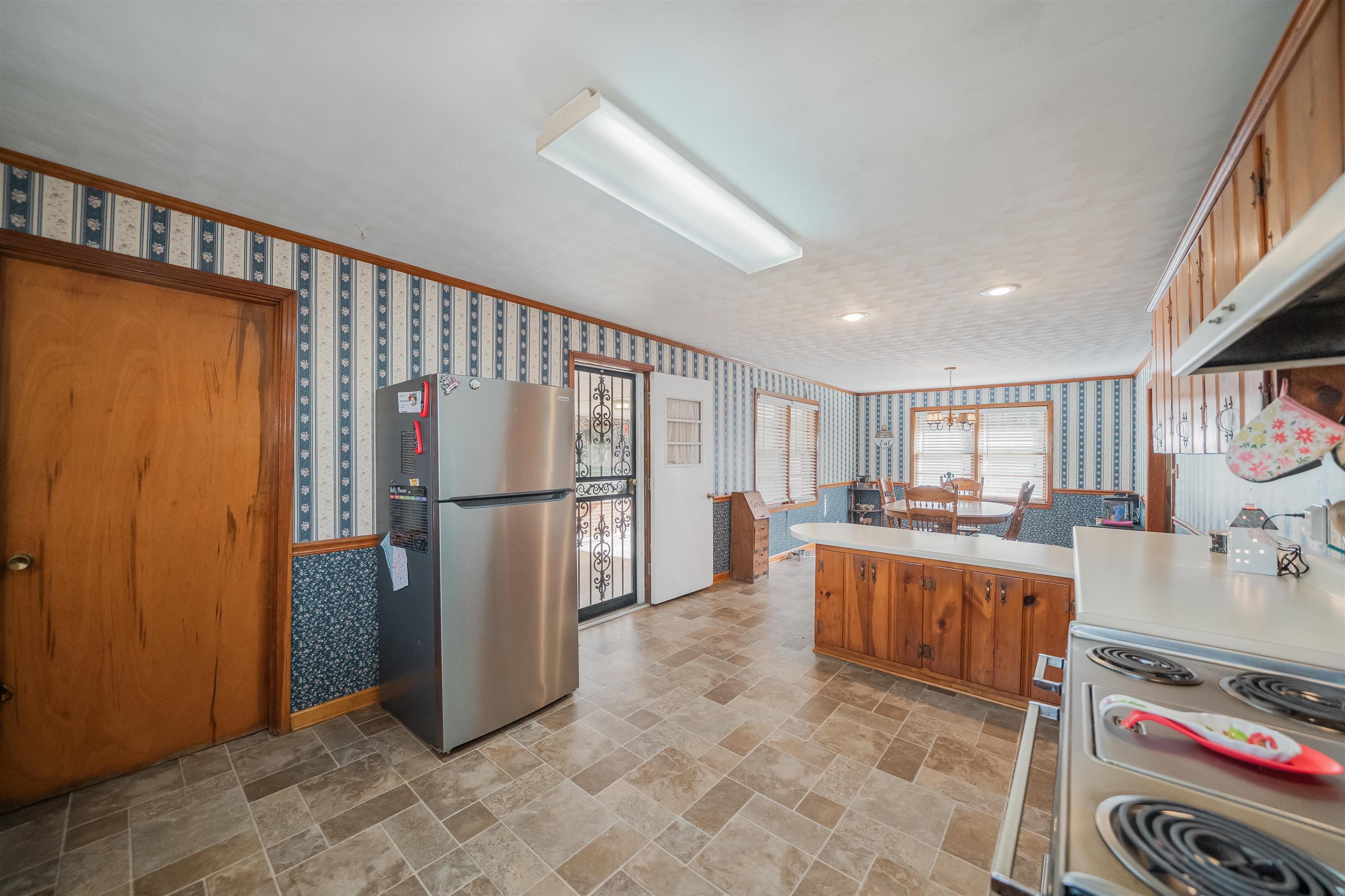 1315 Bishop Road Middleton, TN 38052 - Photo 6 of 31 Kitchen featuring stainless steel fridge, crown molding, and range