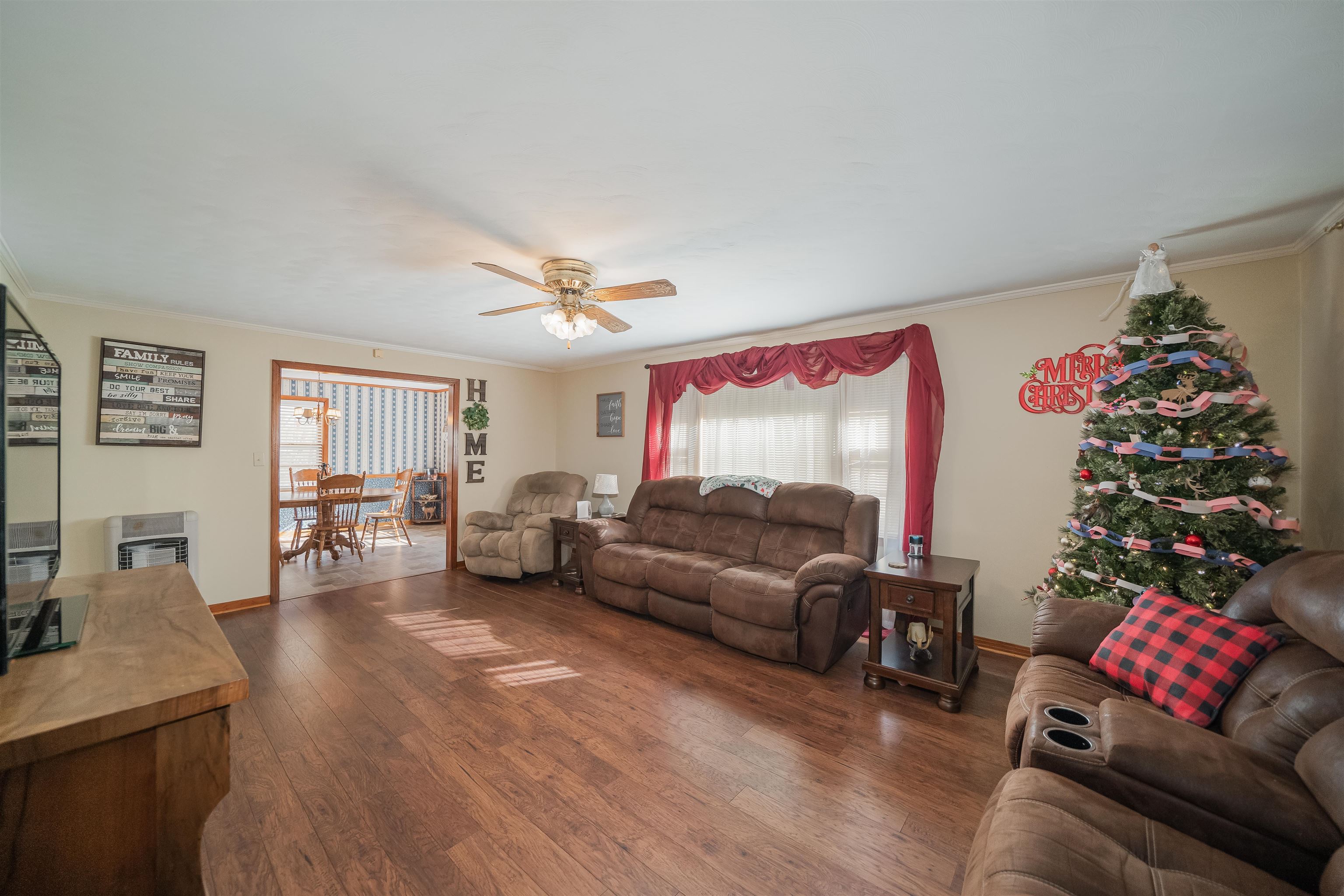 1315 Bishop Road Middleton, TN 38052 - Photo 9 of 31 Living room with heating unit, ceiling fan, dark hardwood / wood-style flooring, and ornamental molding