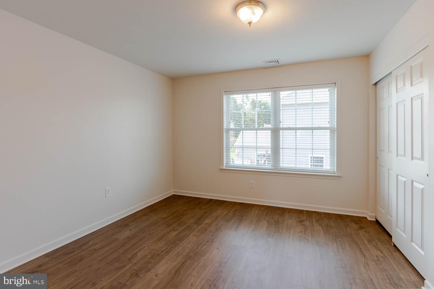151 Rushcliffe Street State College, PA 16803 - Photo 28 of 50 an empty room with wooden floor and windows