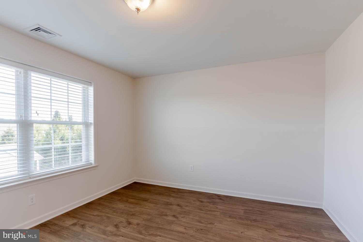 151 Rushcliffe Street State College, PA 16803 - Photo 29 of 50 an empty room with wooden floor and windows