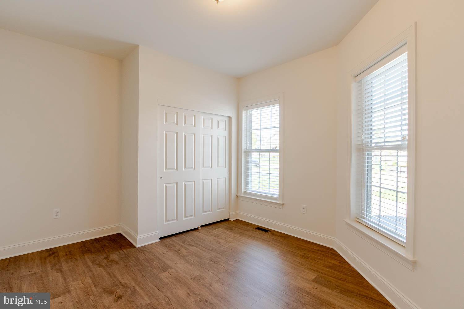 151 Rushcliffe Street State College, PA 16803 - Photo 3 of 50 an empty room with wooden floor and windows with curtains view