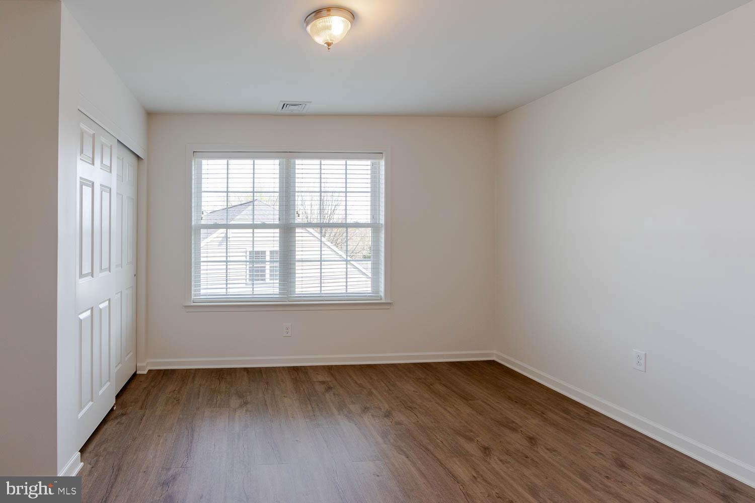 151 Rushcliffe Street State College, PA 16803 - Photo 31 of 50 an empty room with wooden floor and windows