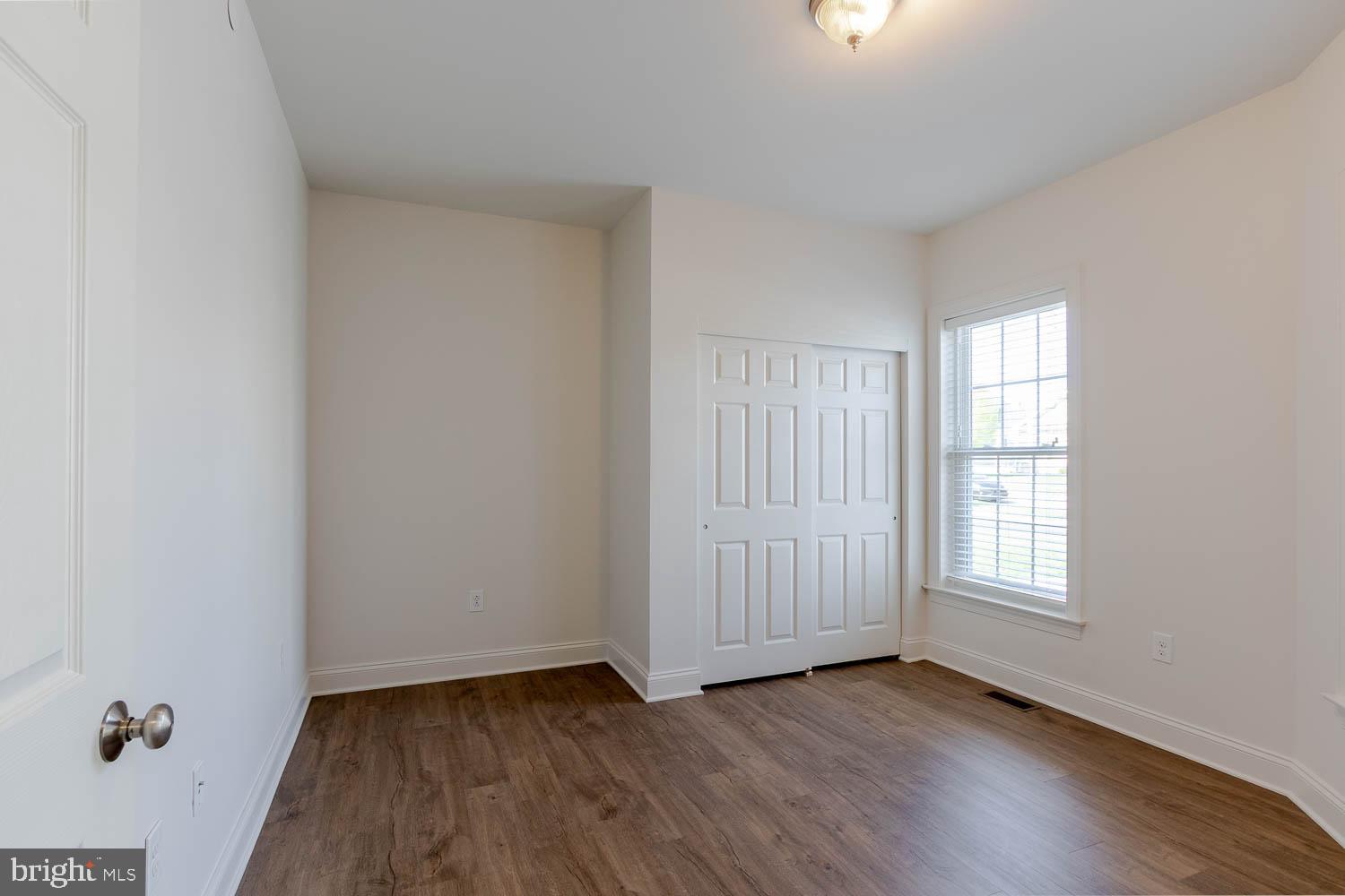 151 Rushcliffe Street State College, PA 16803 - Photo 34 of 50 an empty room with wooden floor and windows