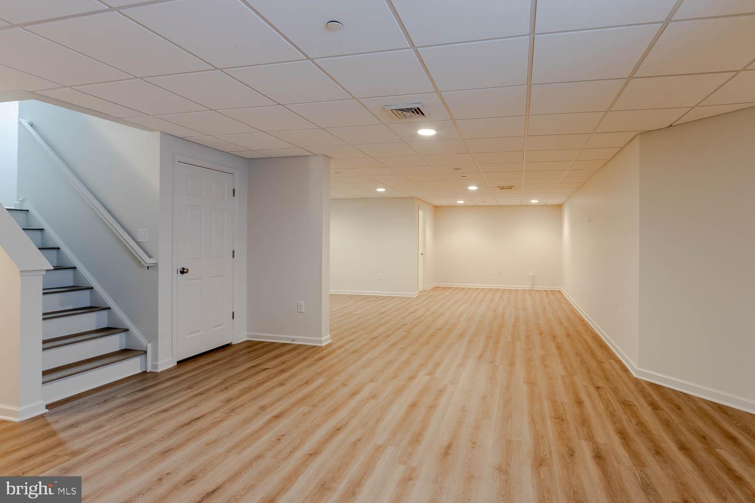 151 Rushcliffe Street State College, PA 16803 - Photo 39 of 50 a view of an empty room with wooden floor and stairs