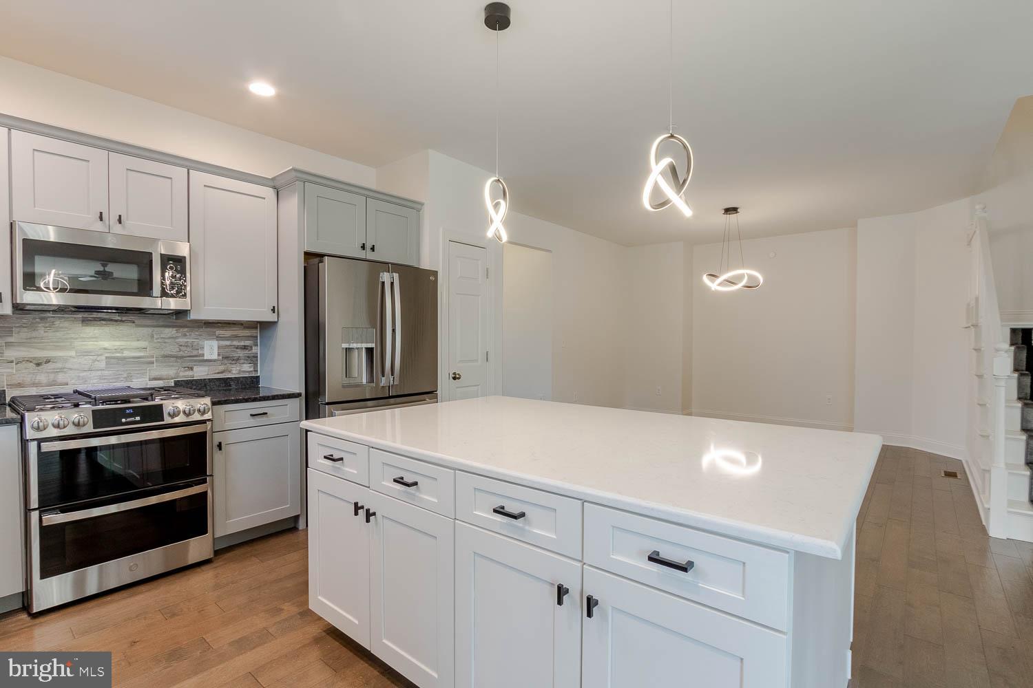 151 Rushcliffe Street State College, PA 16803 - Photo 9 of 50 a kitchen with stainless steel appliances white cabinets and wooden floor
