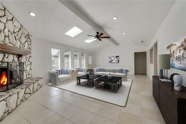 a living room with fireplace furniture and a flat screen tv
