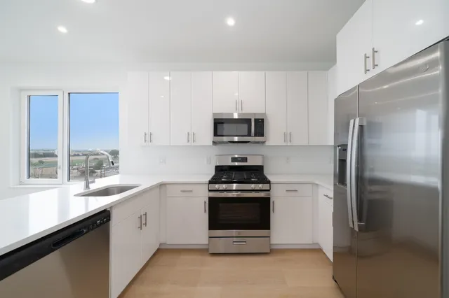 a kitchen with a sink stove and refrigerator