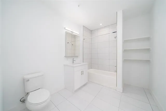 a bathroom with a toilet a sink and bathtub