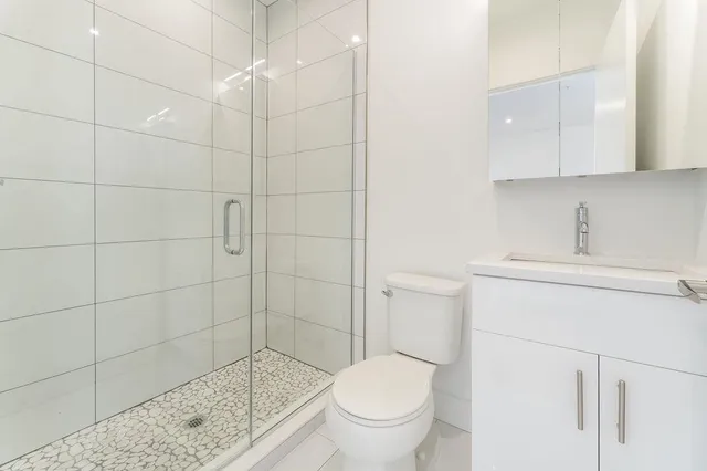 a bathroom with a toilet and a shower