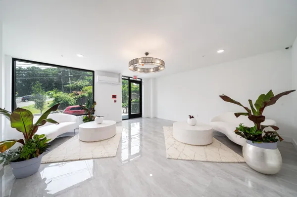 a living room with furniture and a potted plant