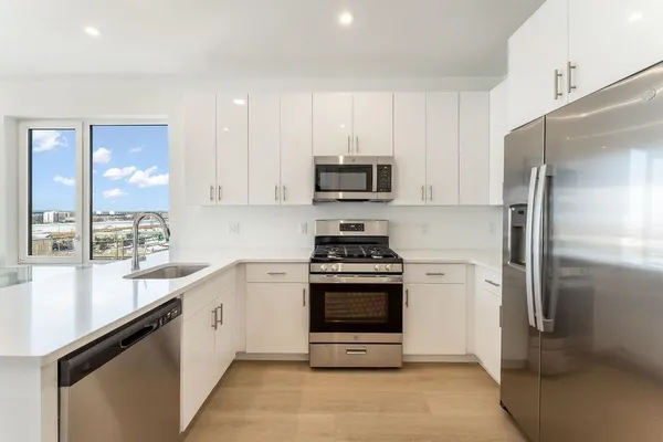 a kitchen with a sink stove and refrigerator