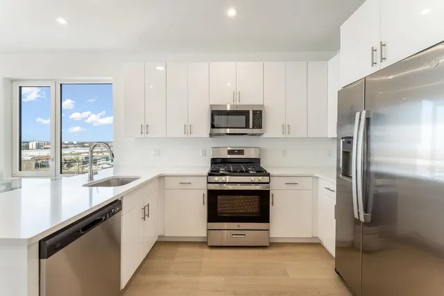 a kitchen with a sink stove and refrigerator