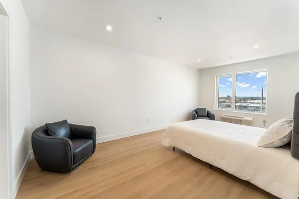 a bedroom with a bed and a couch