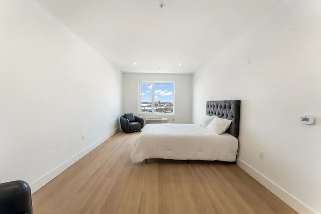 a bedroom with a bed and window