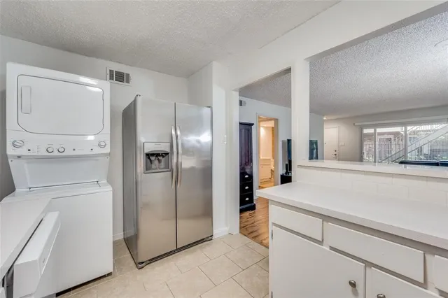 a kitchen with a refrigerator and cabinets
