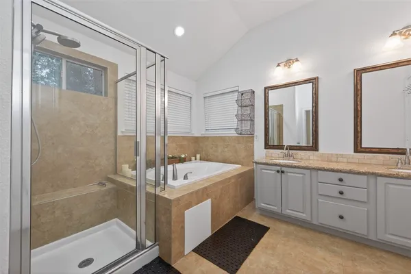 a bathroom with a granite countertop sink mirror and vanity