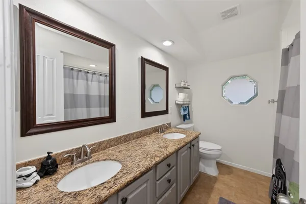 a bedroom with a bed dresser and a window