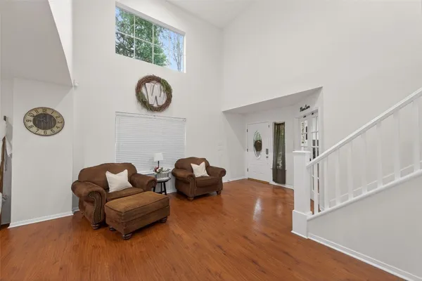 a bedroom with furniture and a flat screen tv