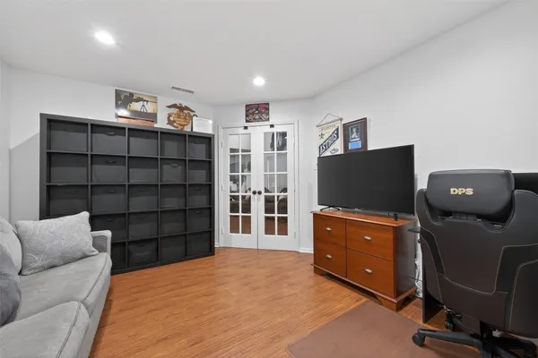 a living room with furniture and wooden floor