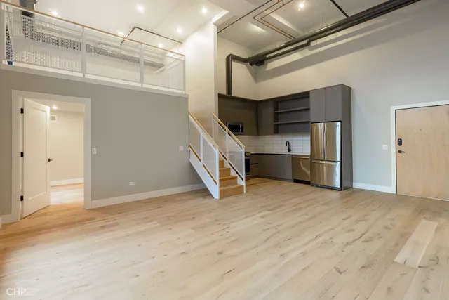 a view of an empty room with a kitchen