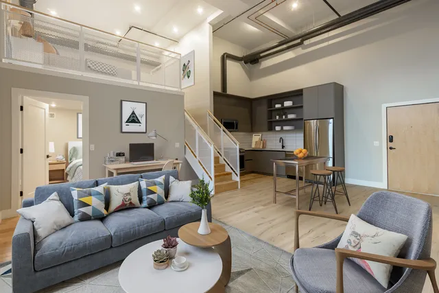a living room with furniture and a wooden floor