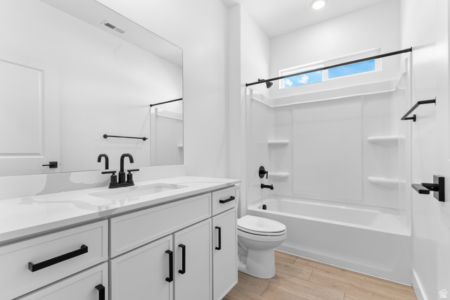 2362 1400 West, Unit 14 Perry, UT 84302 - Photo 8 of 22 Bathroom featuring a white vanity with a light-toned countertop, a rectangular undermount sink, and matte black fixtures