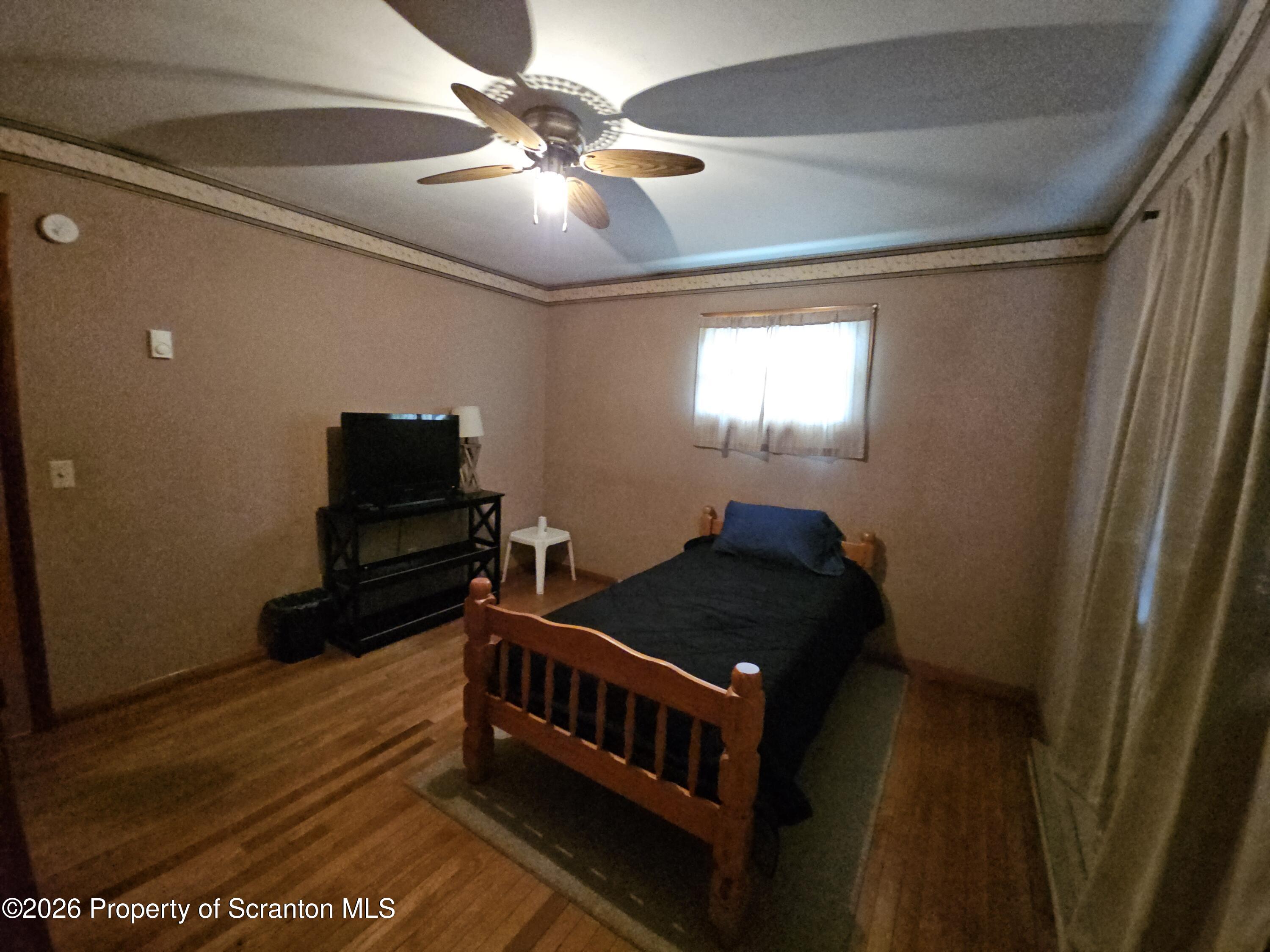 405 Baker Street Taylor, PA 18517 - Photo 22 of 36 a bedroom with a bed and a chandelier