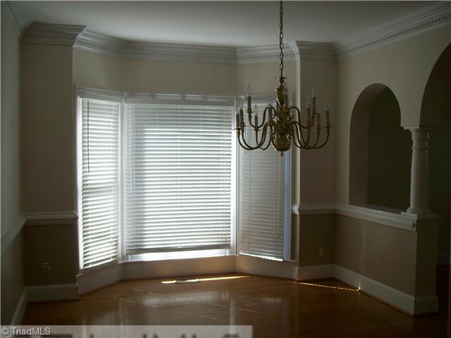 3009 Alamance Road Greensboro, NC 27407 - Photo 3 of 14 Dining Room. Dining room with hardwood floors and arched openings to living room, bay window and wide mouldings.