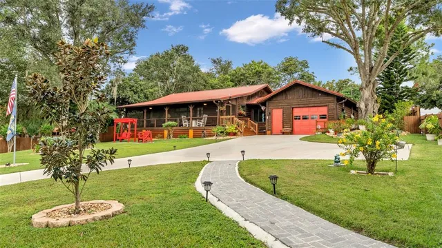 a view of a house with swimming pool and a yard