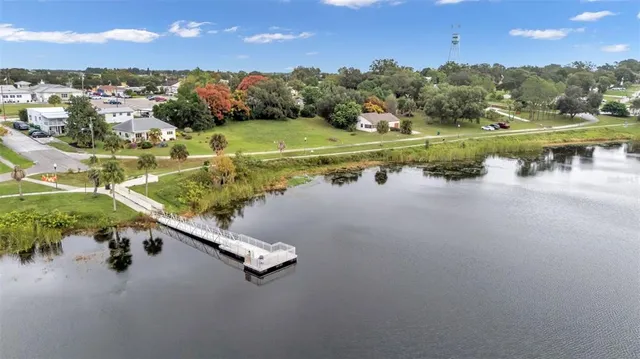 an aerial view of a house with a yard and lake view