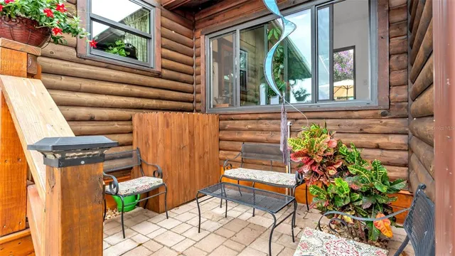 a backyard of a house with table and chairs
