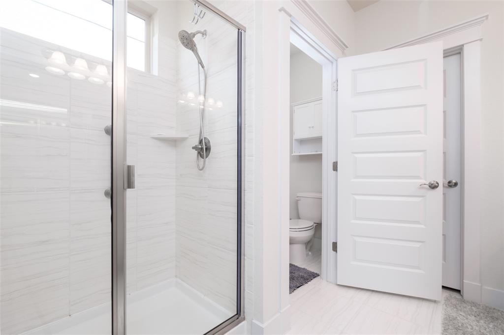 1724 Rowdy Loop Leander, TX 78641 - Photo 11 of 32 Bathroom featuring toilet and a shower stall