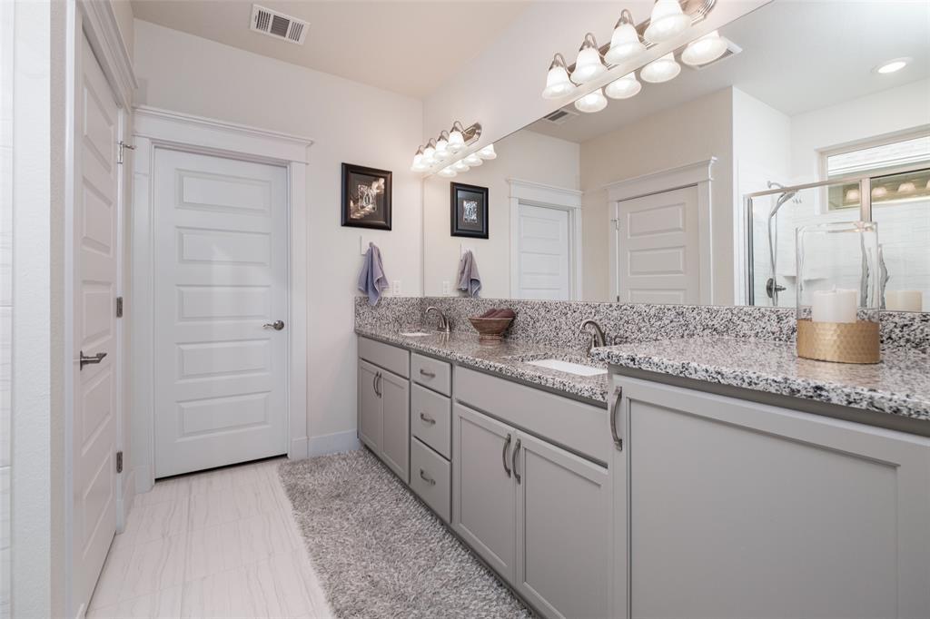 1724 Rowdy Loop Leander, TX 78641 - Photo 12 of 32 Bathroom with double vanity and a stall shower