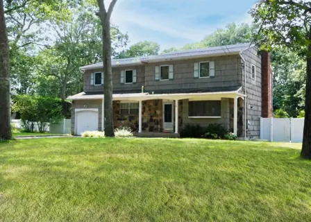 a front view of a house with a garden