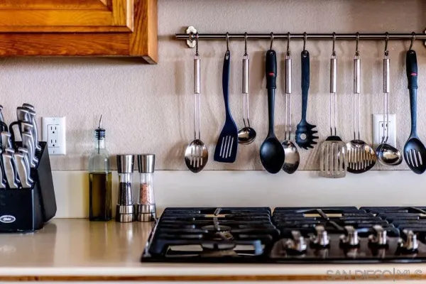 a vase of flowers sitting on a table with chairs