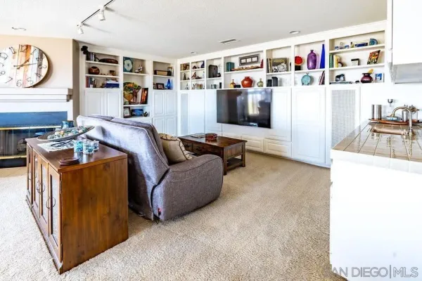 a living room with furniture wooden floor and a large window