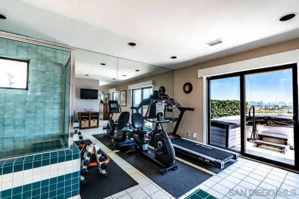 a living room with furniture a fireplace and a large window