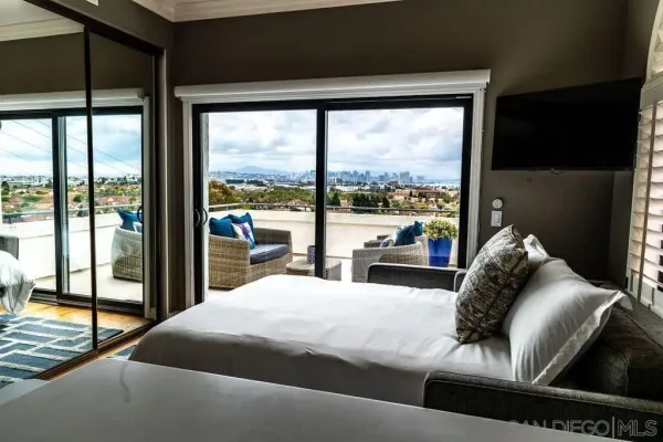 a bedroom with a bed and a large window